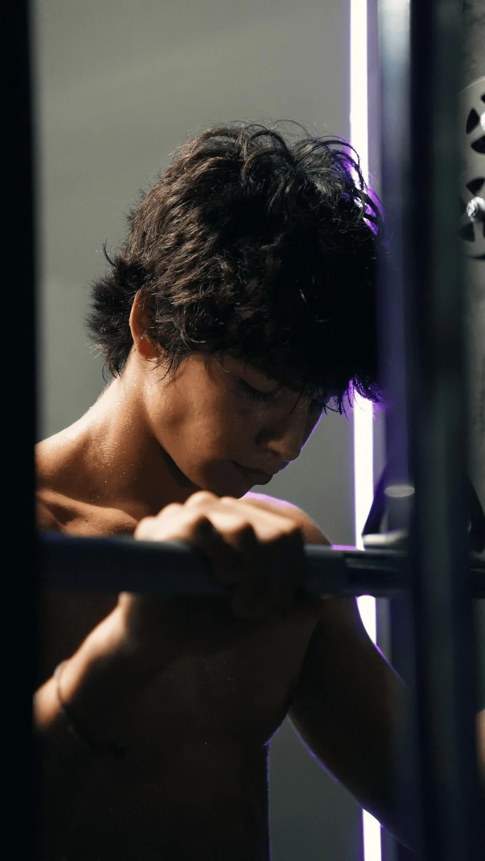 A person doing pull-ups in the gym